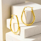 25MM Oval Sectioned Diamond Cut Hoops in 14K Gold